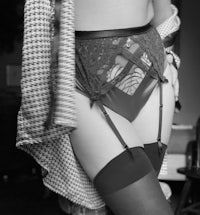 a black and white photo of a woman in lingerie